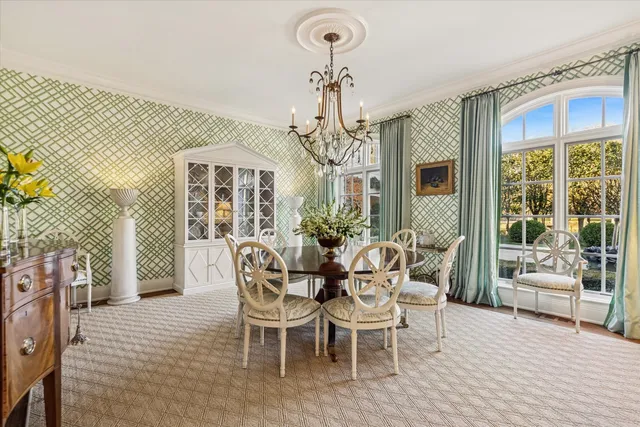 a living room with furniture chandelier and a fireplace
