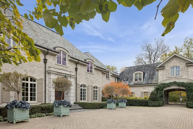 an aerial view of a house with swimming pool and lake view