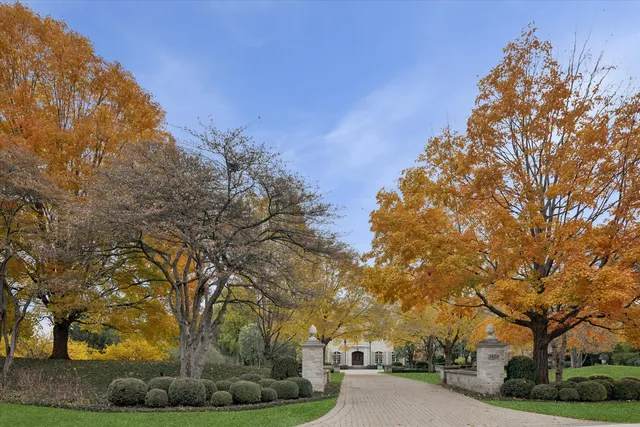 a dining room with chandelier and wooden floor