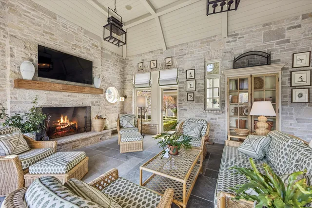 a view of a hallway with wooden floor and a living room