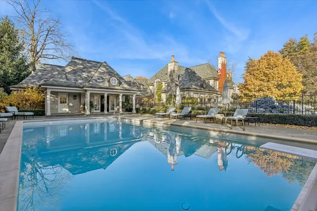 an aerial view of a house with swimming pool garden and outdoor seating