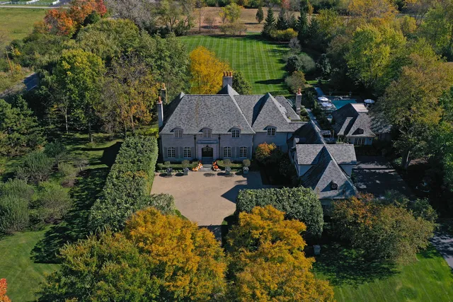 a dining room with furniture a chandelier and wooden floor