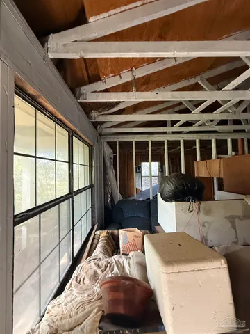 a living room with furniture and large windows