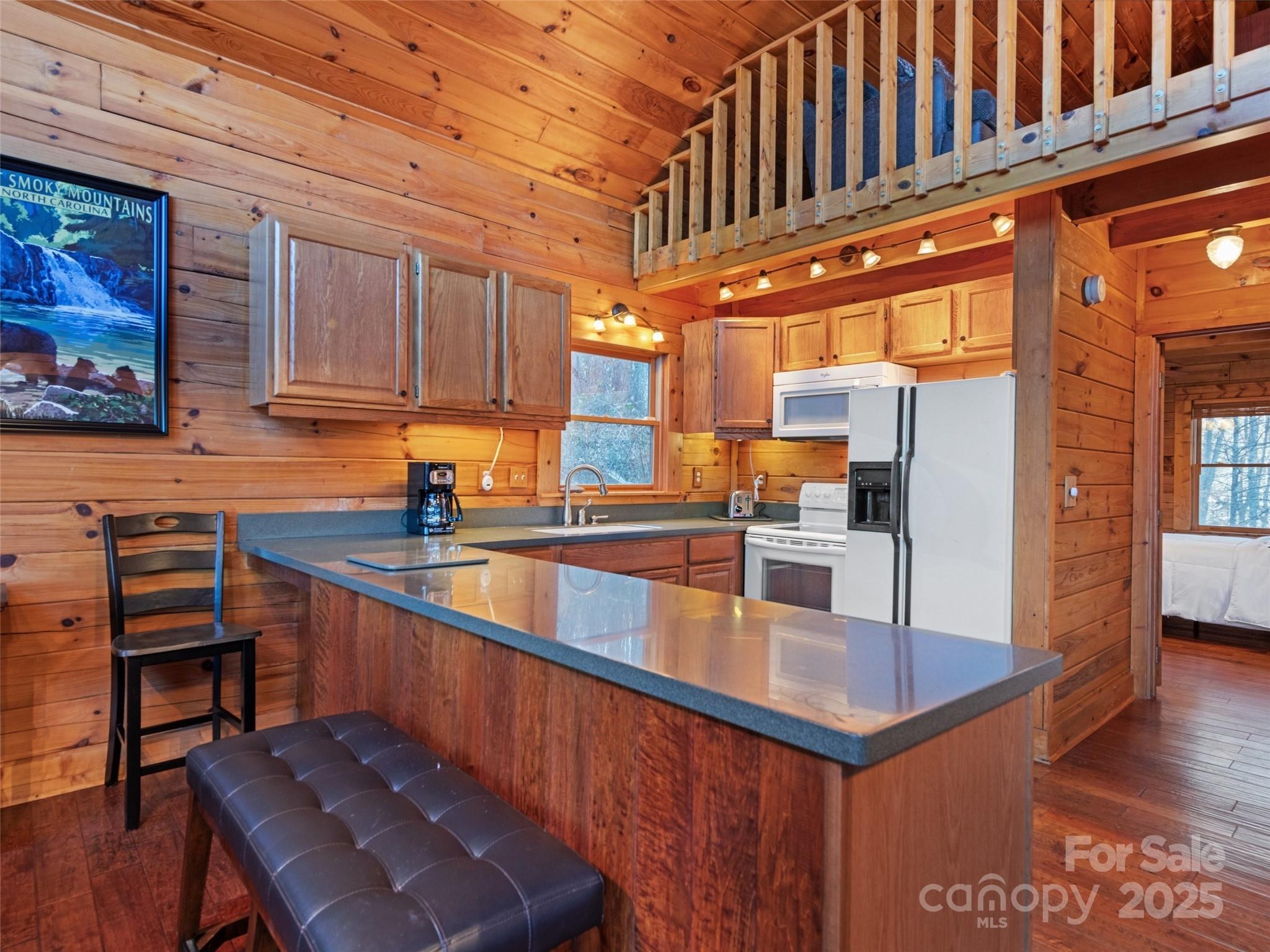 36 Wonder View Point Waynesville, NC 28785 - Photo 17 of 40 a kitchen with stainless steel appliances granite countertop a sink a stove and a wooden floors