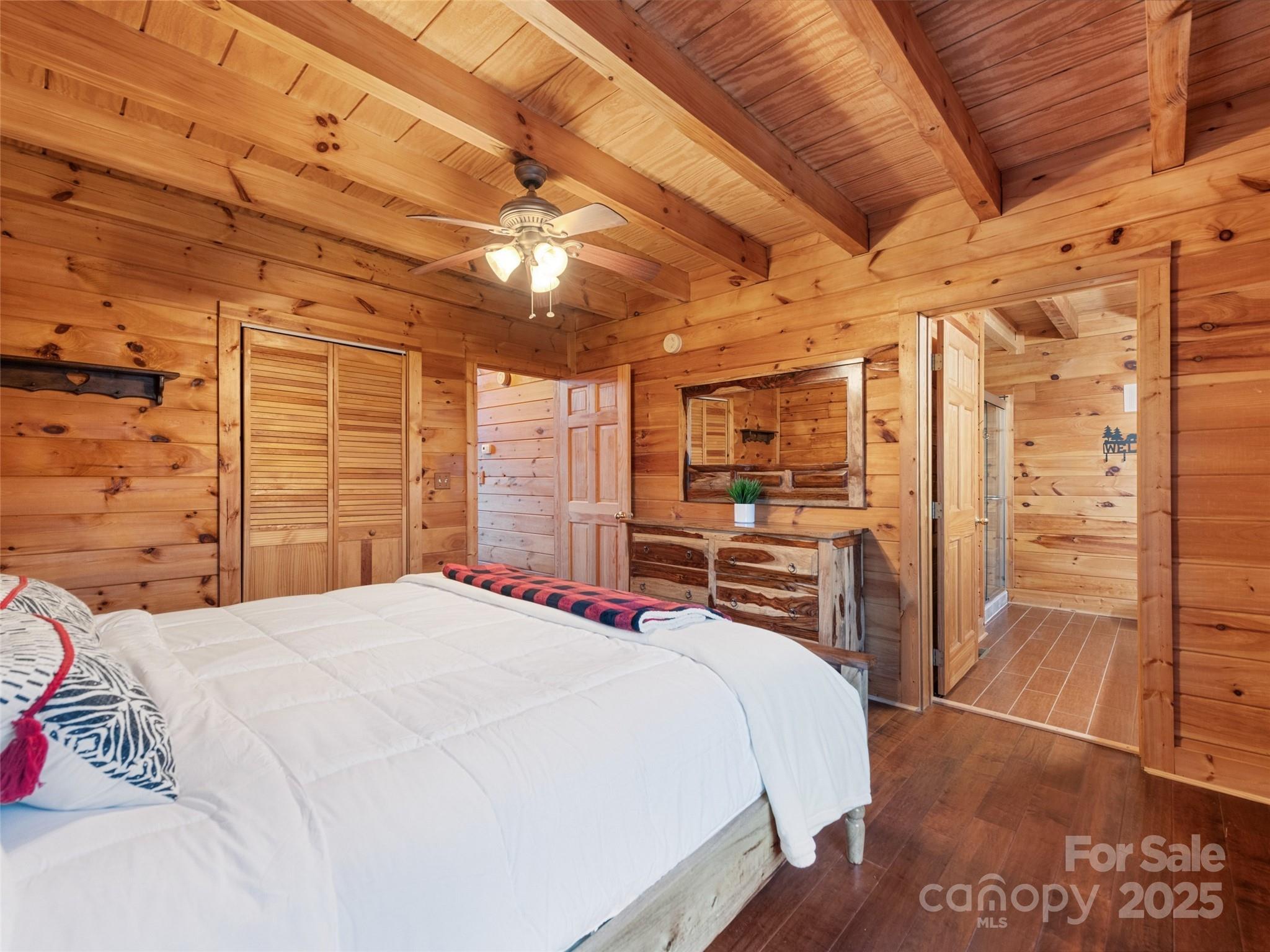 36 Wonder View Point Waynesville, NC 28785 - Photo 22 of 40 a large bed sitting in a bedroom next to a cabinet
