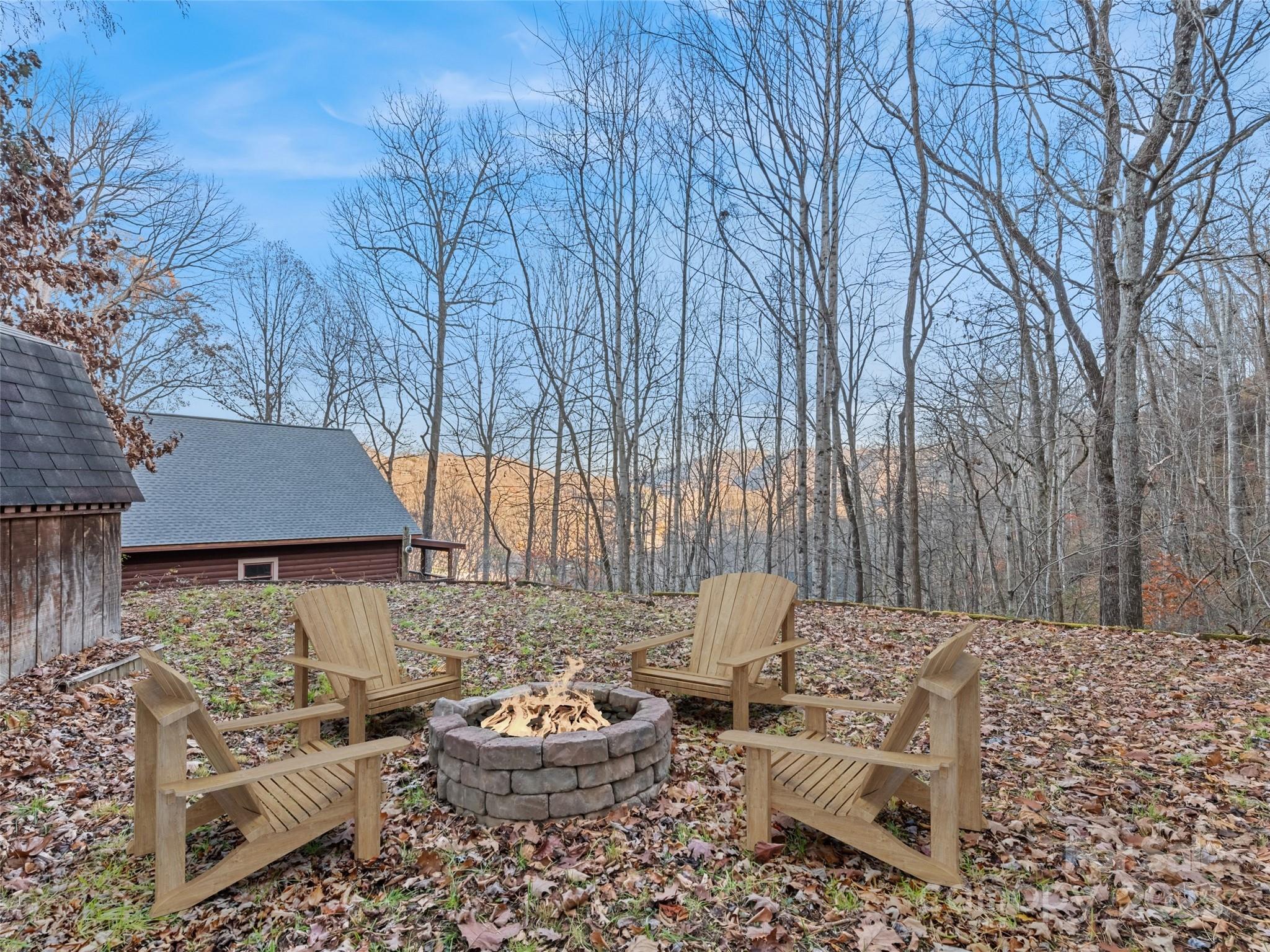 36 Wonder View Point Waynesville, NC 28785 - Photo 8 of 40 a backyard of a house with fire pit and outdoor seating