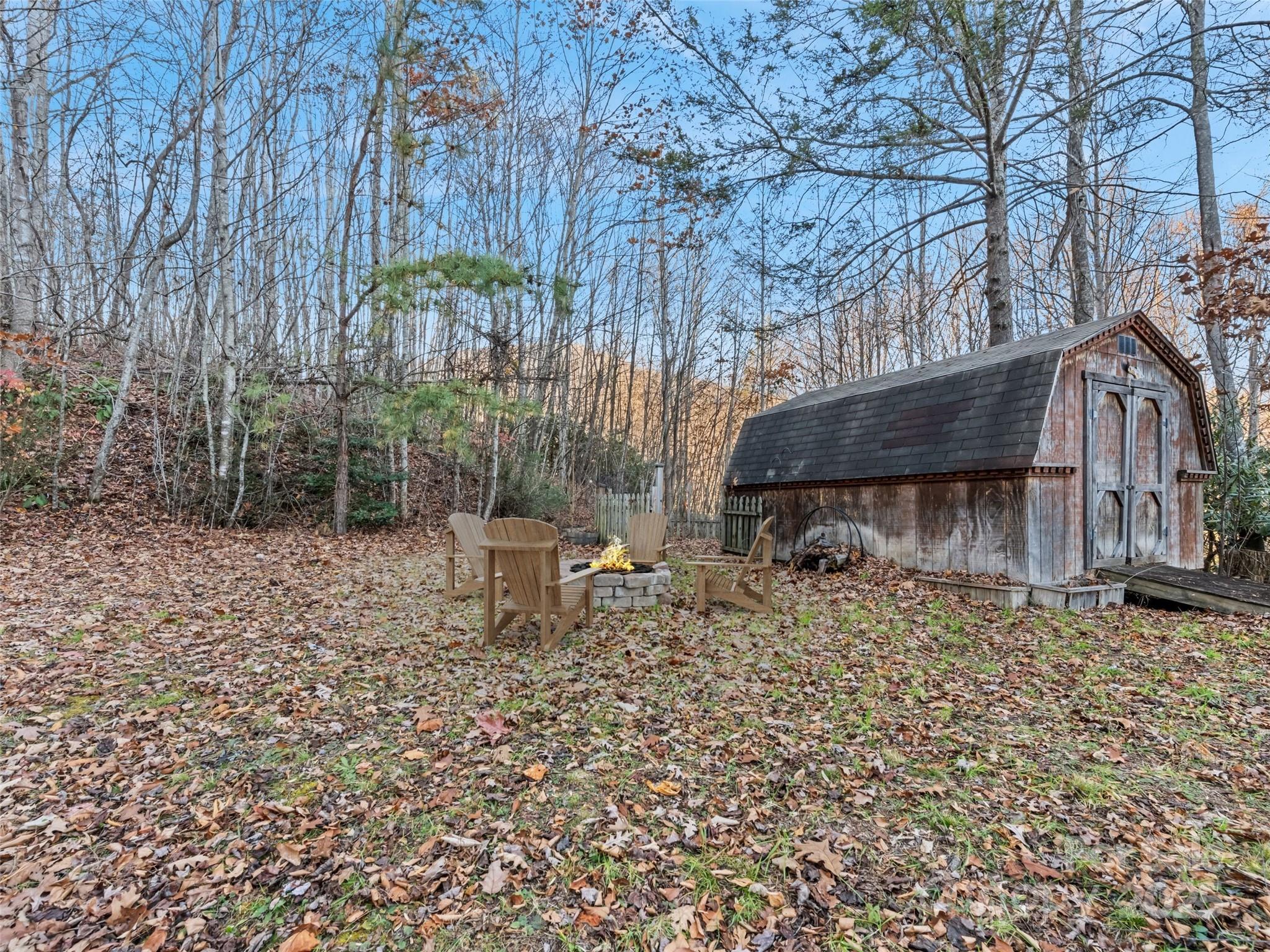 36 Wonder View Point Waynesville, NC 28785 - Photo 9 of 40 a backyard of a house with table and chairs