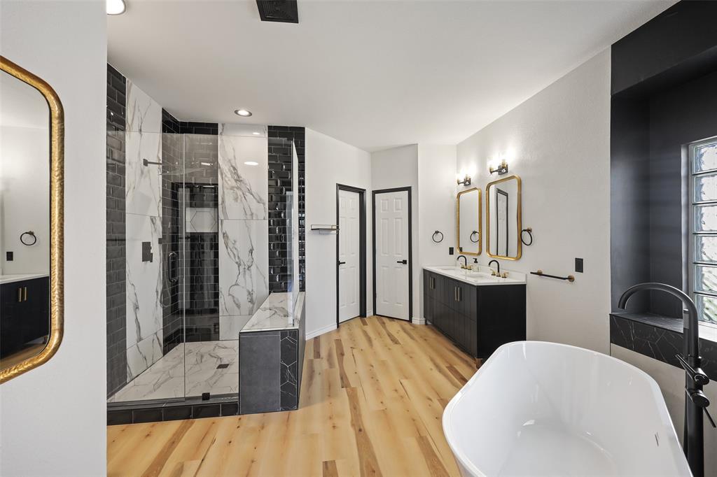 a en suite bathroom with a double vanity sink a mirror and shower