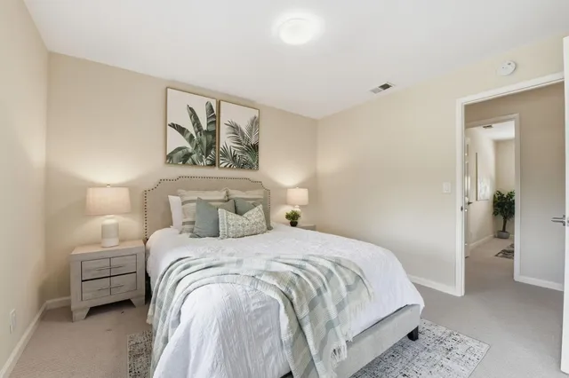 a bedroom with a bed and a couch