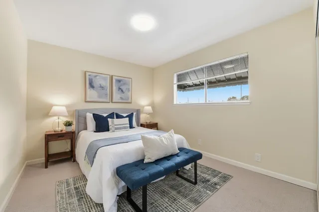 a bedroom with a bed and a painting on the wall