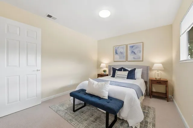 a bedroom with a bed and a table