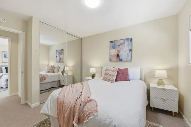 a bedroom with a bed and a couch