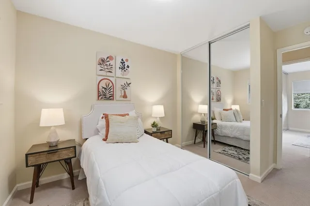 a bedroom with a bed and a lamp