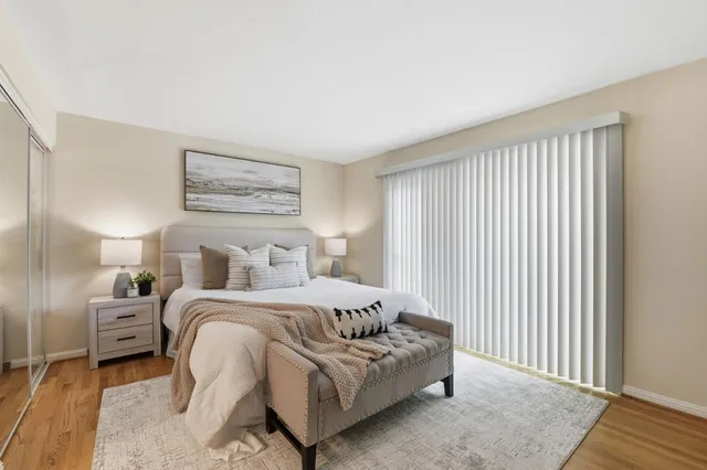 a bedroom with a bed and a night stand