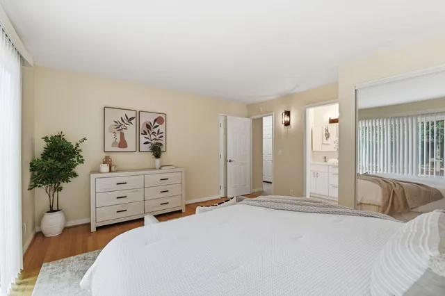 a bedroom with a bed and a potted plant