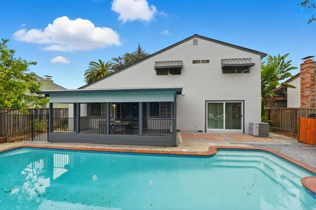 a front view of a house with a yard and seating space