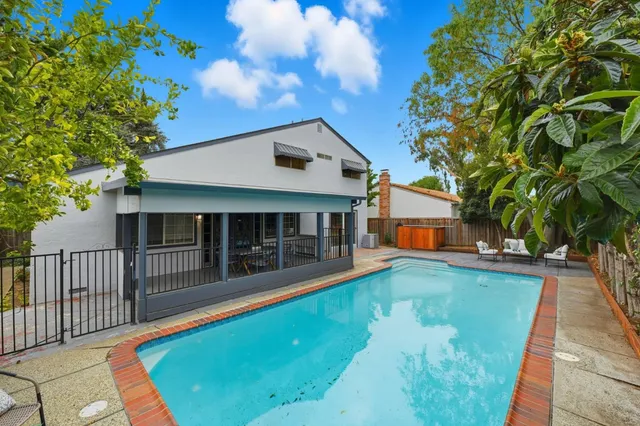 a view of a house with a backyard