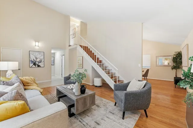 a living room with furniture and wooden floor