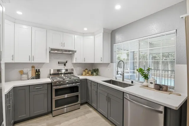 a kitchen with a sink stove and cabinets