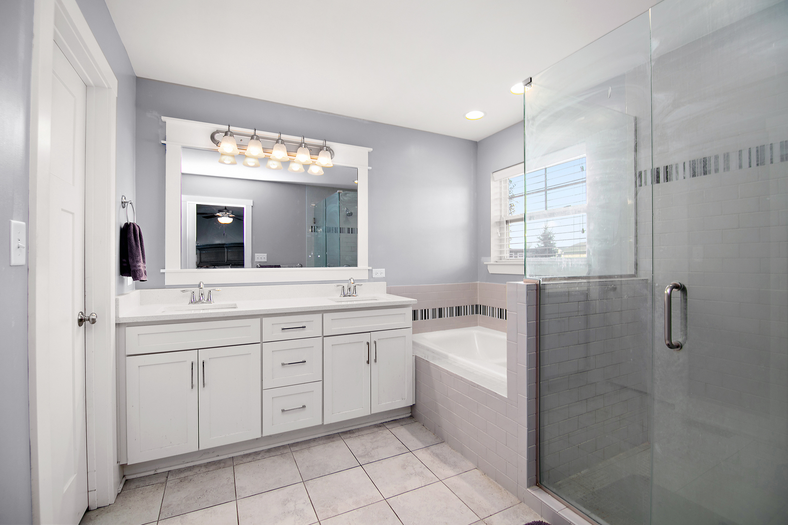 489 Cardinal Drive Manteno, IL 60950 - Photo 18 of 38 a spacious bathroom with a double vanity sink a mirror and a bathtub