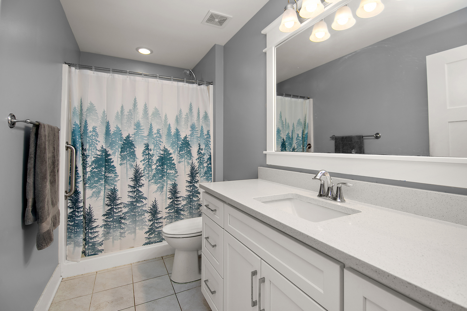 489 Cardinal Drive Manteno, IL 60950 - Photo 23 of 38 a bathroom with a granite countertop sink a toilet a mirror and shower curtain