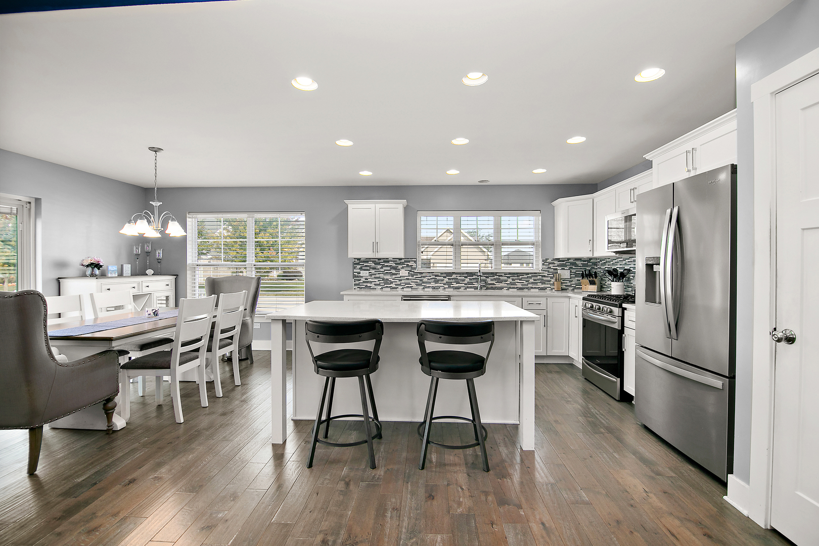 489 Cardinal Drive Manteno, IL 60950 - Photo 6 of 38 a kitchen with refrigerator a sink and chairs