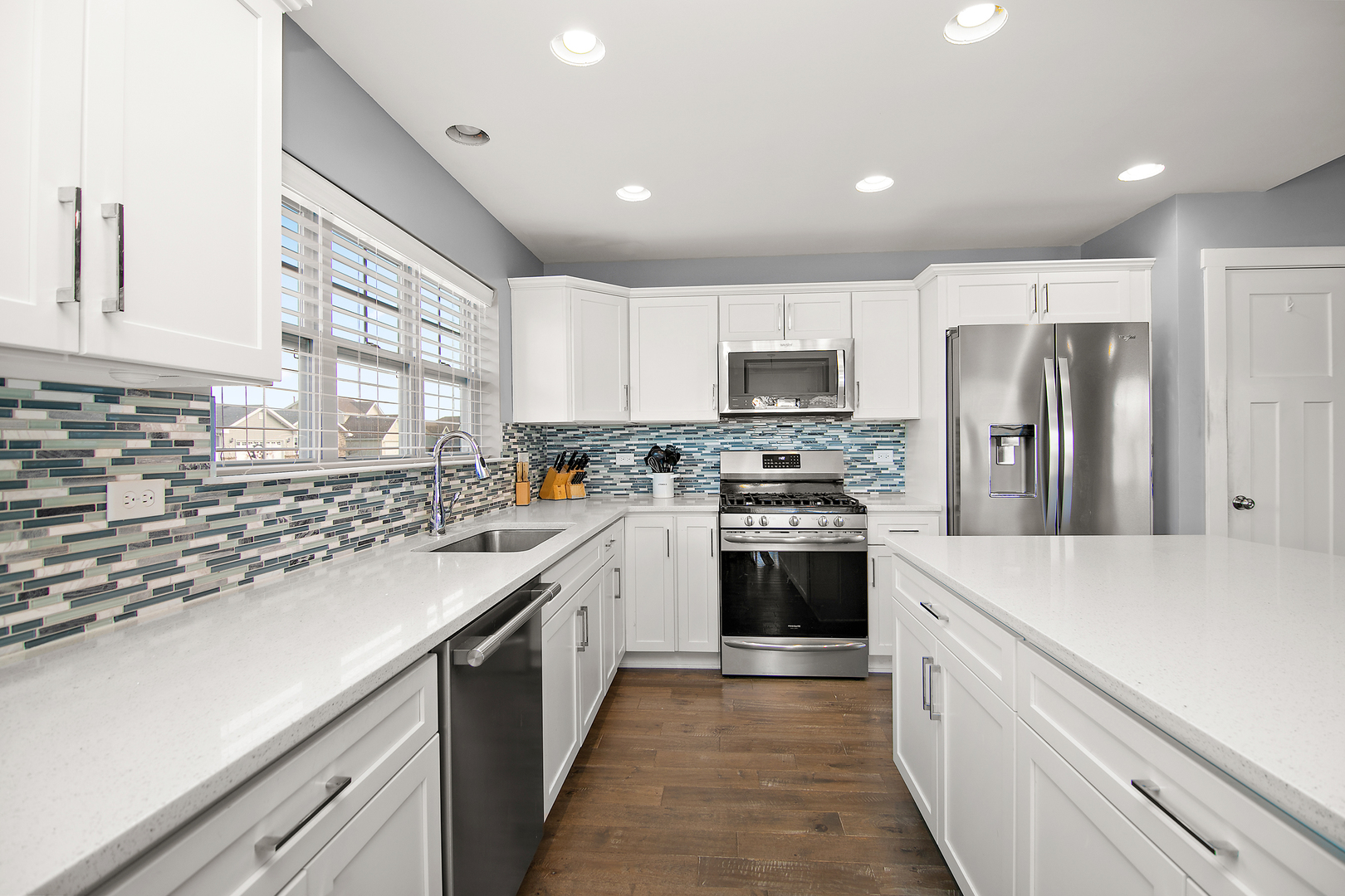 489 Cardinal Drive Manteno, IL 60950 - Photo 8 of 38 a kitchen with stainless steel appliances a refrigerator sink and microwave