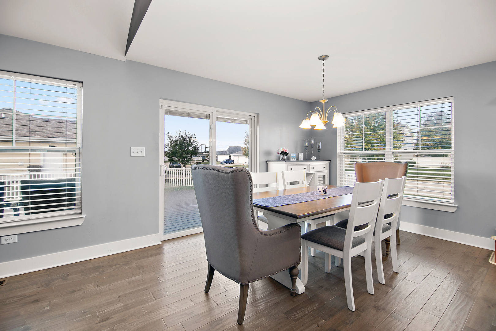 489 Cardinal Drive Manteno, IL 60950 - Photo 9 of 38 a dining room with furniture a chandelier and wooden floor
