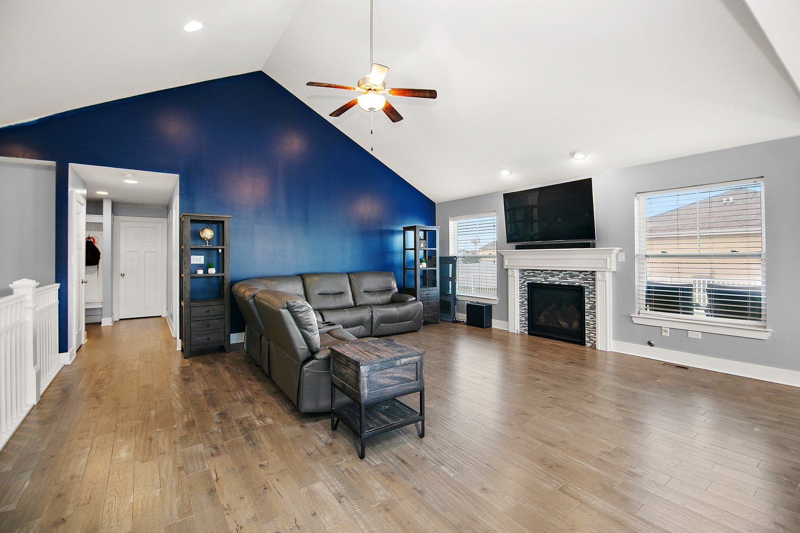 489 Cardinal Drive Manteno, IL 60950 - Photo 10 of 38 a living room with furniture a fireplace and a flat screen tv