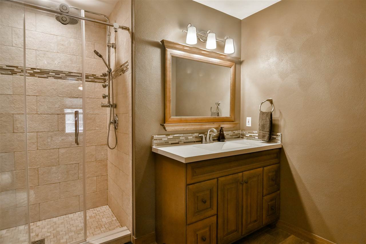 693 Bayfield Road Rockton, IL 61073 - Photo 14 of 26 a bathroom with a sink mirror and a shower