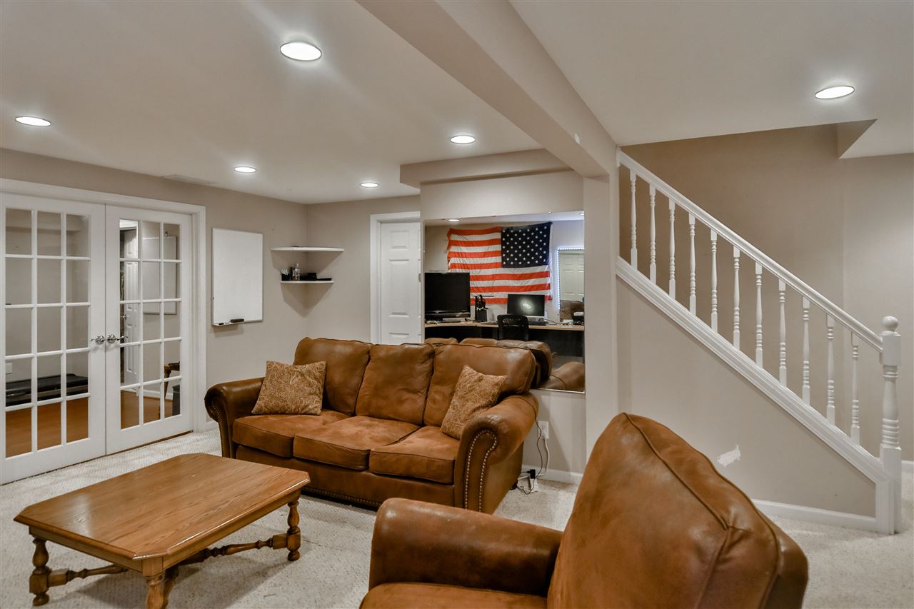 693 Bayfield Road Rockton, IL 61073 - Photo 17 of 26 a living room with furniture ceiling fan and a wooden floor