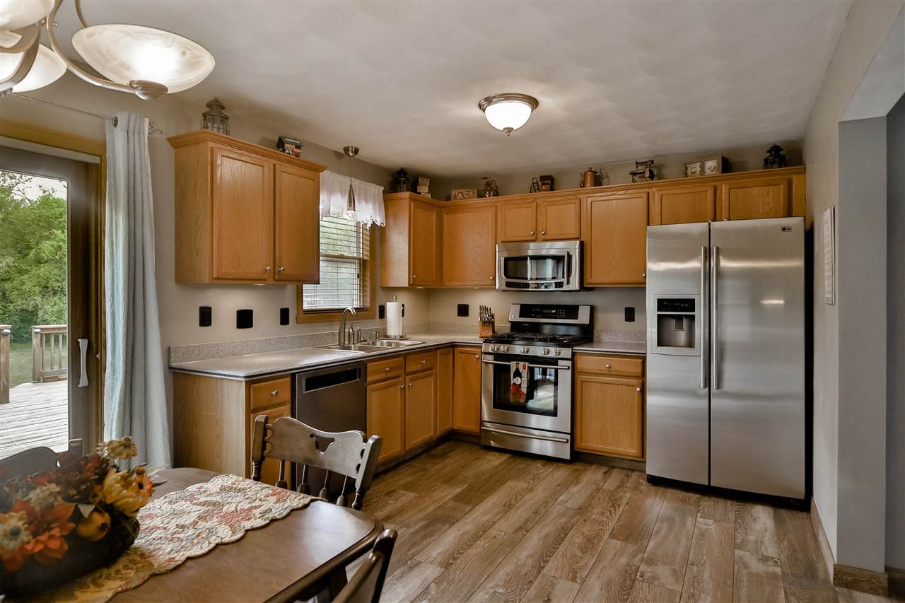 693 Bayfield Road Rockton, IL 61073 - Photo 7 of 26 a kitchen with kitchen island a counter top space a sink stainless steel appliances and cabinets