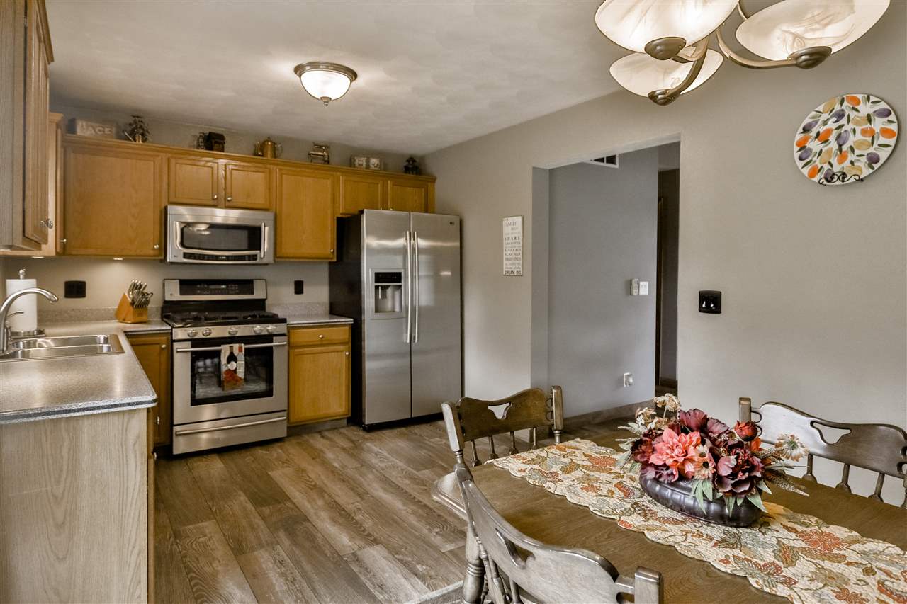 693 Bayfield Road Rockton, IL 61073 - Photo 9 of 26 a kitchen with stainless steel appliances kitchen island granite countertop a refrigerator and a stove top oven
