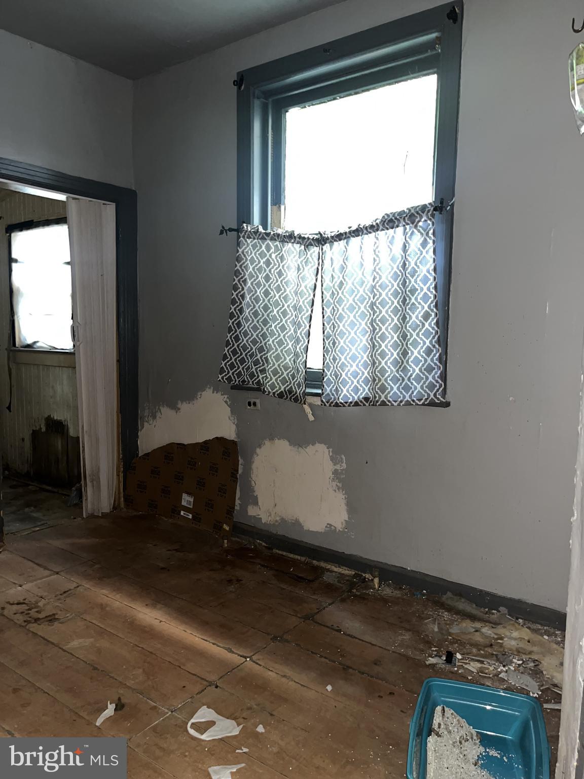 2736 North 24th Street Philadelphia, PA 19132 - Photo 11 of 14 an empty room with wooden floor and windows