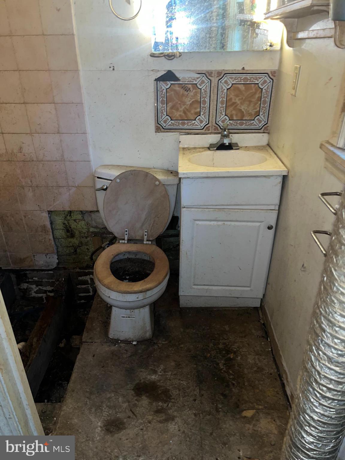 2736 North 24th Street Philadelphia, PA 19132 - Photo 13 of 14 a bathroom with a toilet and a sink
