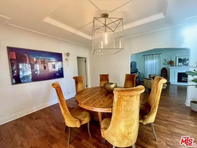 a view of a dining room with furniture wooden floor and chandelier