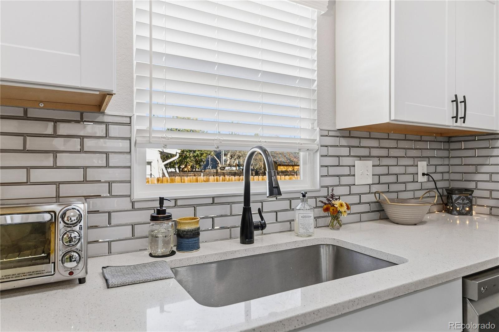 1620 Galena Street Aurora, CO 80010 - Photo 12 of 31 a kitchen with a sink and a wooden floor