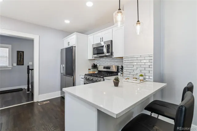 a kitchen with stainless steel appliances a microwave sink refrigerator and microwave