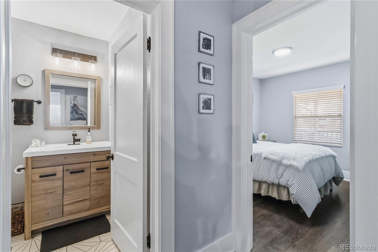1620 Galena Street Aurora, CO 80010 - Photo 16 of 31 a en suite bathroom with a double vanity sink and mirror
