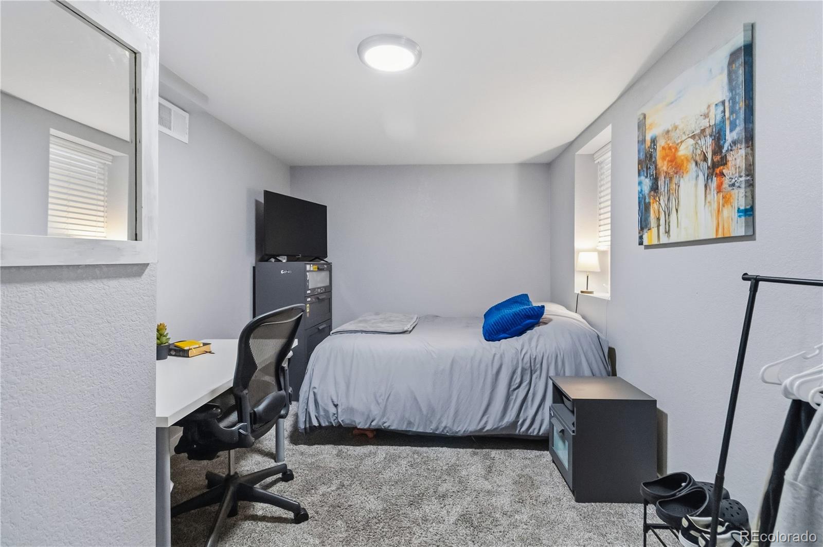 1620 Galena Street Aurora, CO 80010 - Photo 21 of 34 a bedroom with a bed and wooden floor