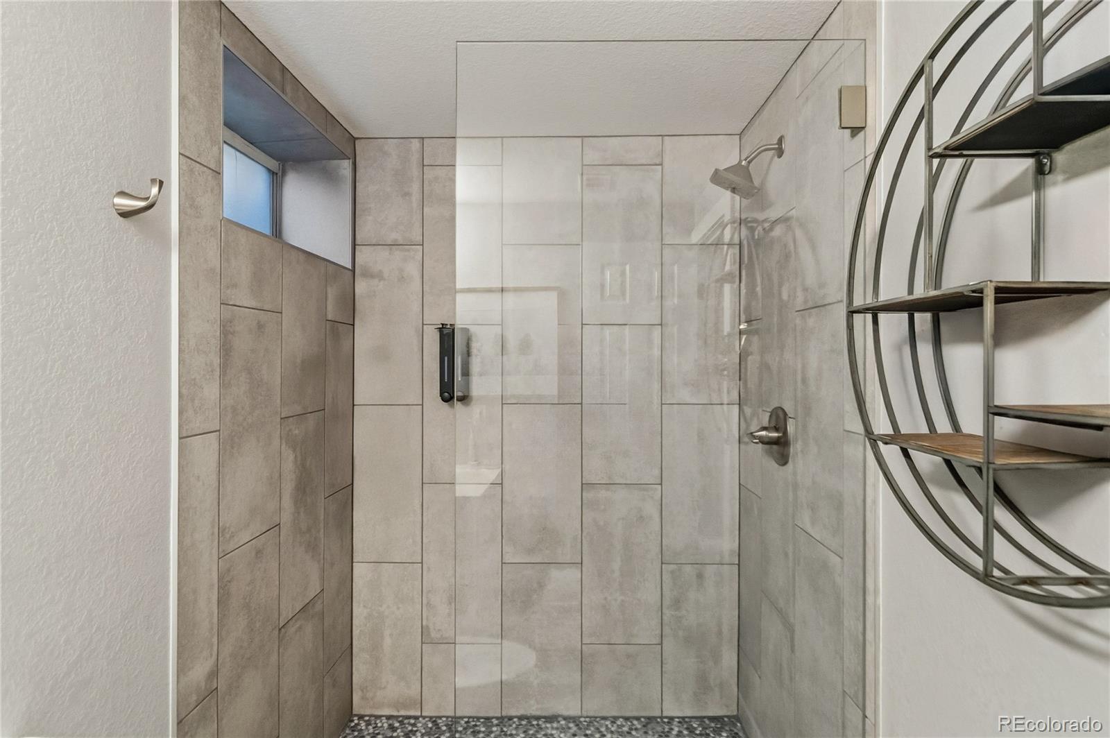1620 Galena Street Aurora, CO 80010 - Photo 23 of 31 a bathroom with a shower and a sink