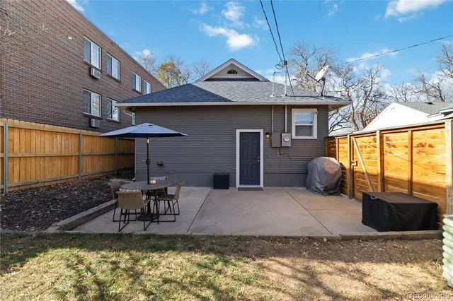 a view of a house with backyard porch and sitting area