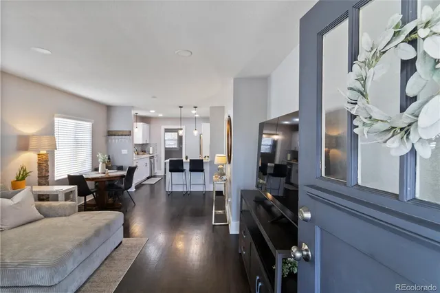 a living room with furniture and a chandelier