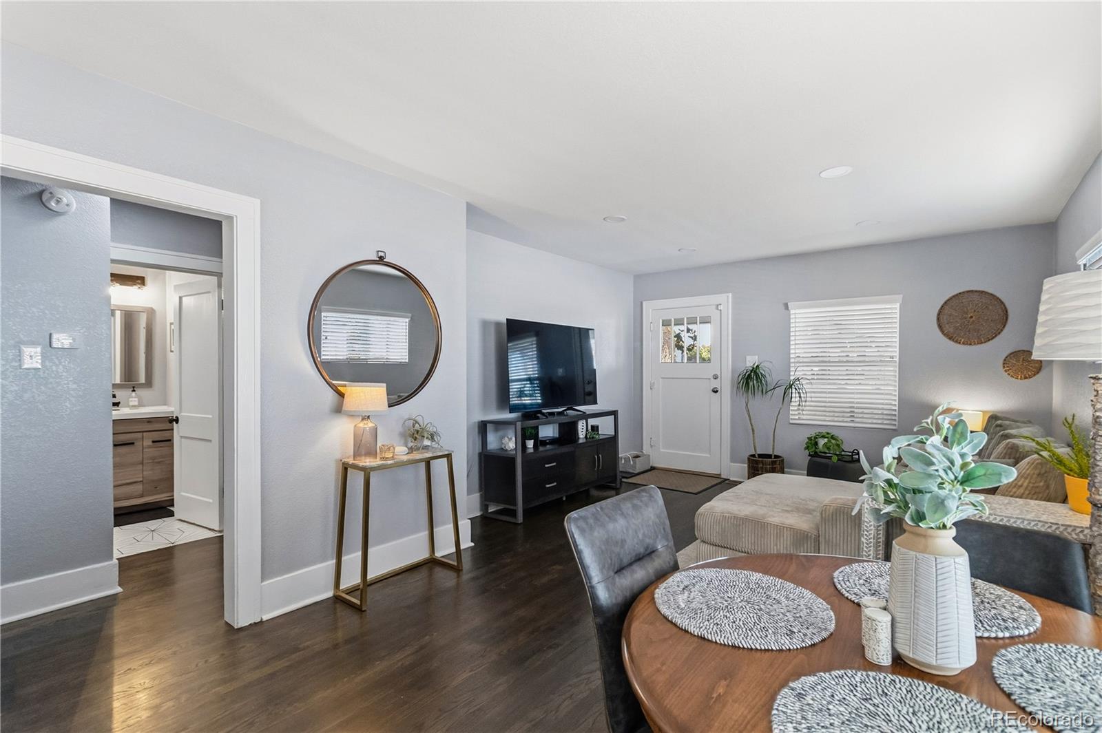 1620 Galena Street Aurora, CO 80010 - Photo 7 of 31 a living room with furniture a rug and a flat screen tv
