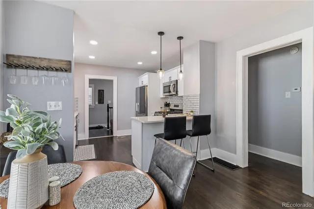 a living room with furniture and a kitchen view