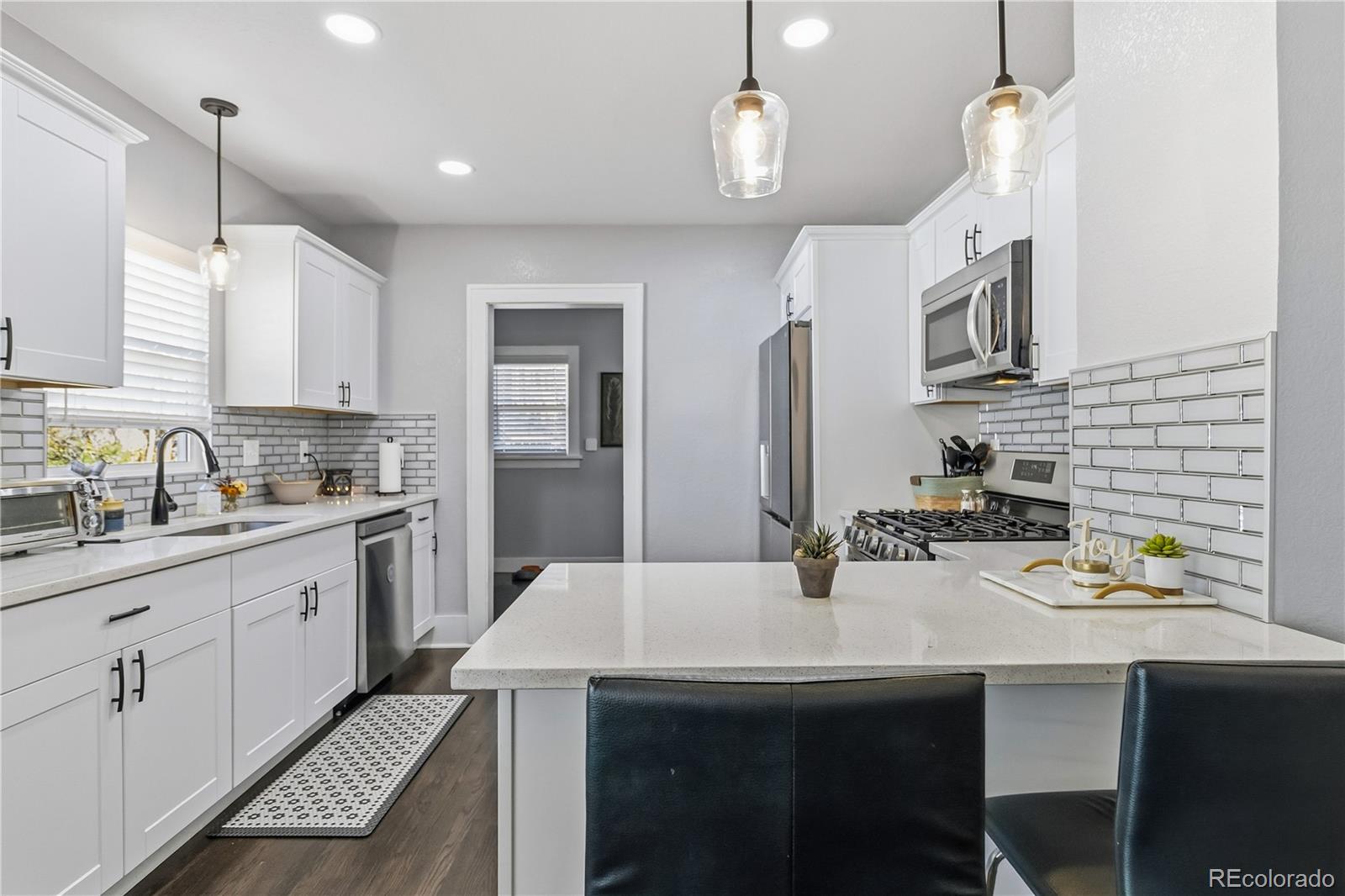 1620 Galena Street Aurora, CO 80010 - Photo 10 of 34 a kitchen with a sink a stove and cabinets
