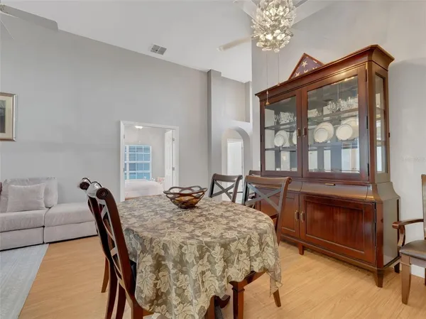 a view of a dining room with furniture and chandelier