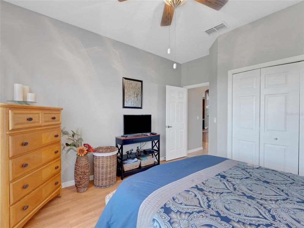 411 Ridge View Drive Davenport, FL 33837 - Photo 7 of 24 a bedroom with a bed and wooden floor