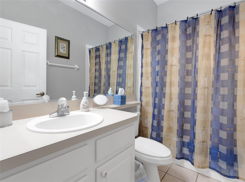 411 Ridge View Drive Davenport, FL 33837 - Photo 8 of 24 a bathroom with a sink toilet and shower