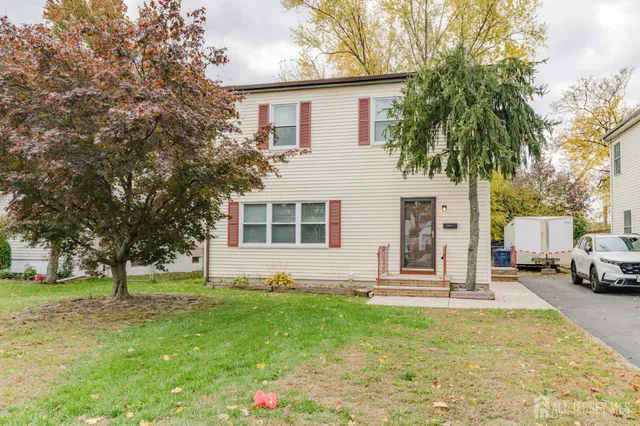 a front view of house with yard and green space